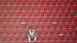 Bayern Munich substitute Lukas Mai in the stands wearing a protective face