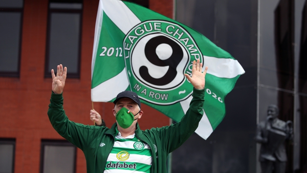A fan celebrates after Celtic were crowned Scottish Premiership champions