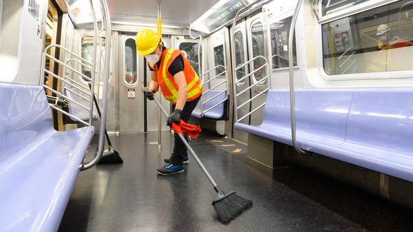 A cleaning contractor cleans and disinfects a New York City subway car