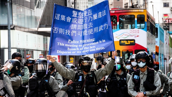 Hong Kong Police raise the blue flag warning protesters, press and pedestrians to disperse during demonstrations in Hong Kong on Sunday