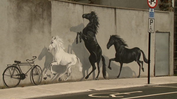 A striking mural of horses and an old bicycle adorns one Tralee wall