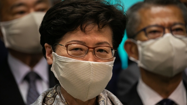 Carrie Lam's move comes after 12 pro-democracy candidates were disqualified from running in the poll