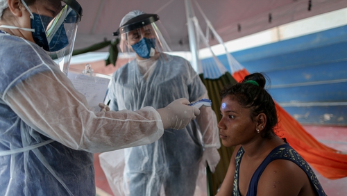 Doctors Without Borders medics check a woman's tempature in Manaus, Brazil