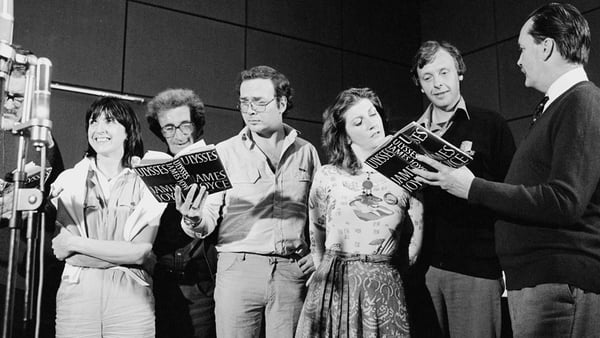 The RTÉ Players record James Joyce's novel 'Ulysses', which was broadcast unedited and uninterrupted by RTÉ Radio 1 (Medium Wave) between 16 and 17 June 1982. The players are standing around the microphone holding their scripts, probably in Studio 1 in RT