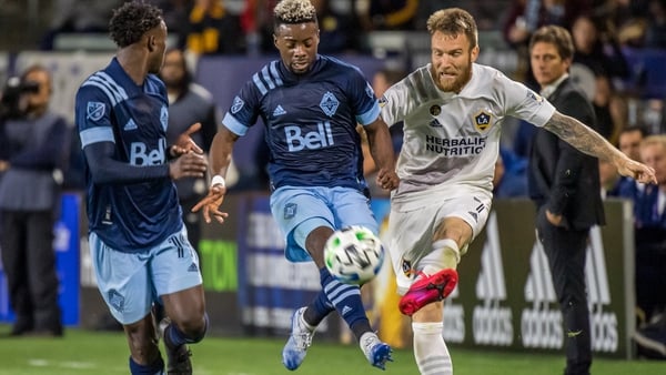 Aleksandar Katai (right) delivers a cross in the LA Galaxy's encounter with the Vancouver Whitecaps in March