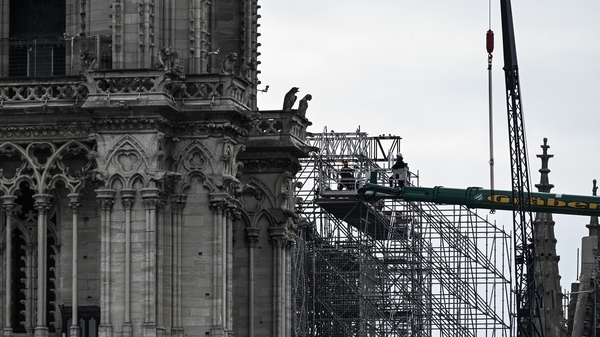 Workers dismantling the scaffolding at the Notre-Dame Cathedral in Paris