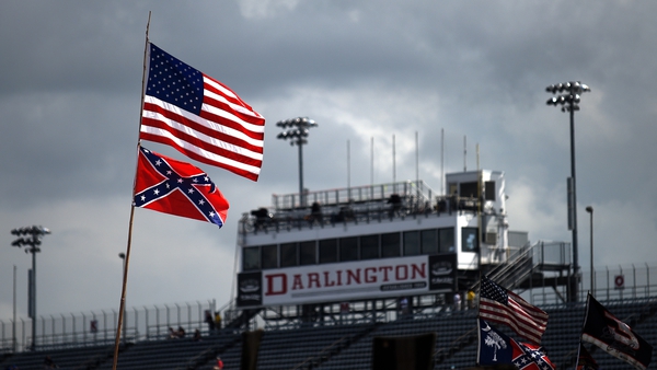 The Confederate flag flutters in the breeze beneath the Stars and Stripes at Darlington Raceway in South Carolina in 2015