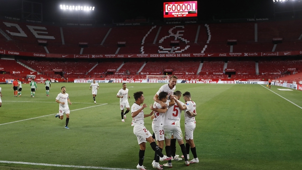 Sevilla players celebrate after Lucas Ocampos gave the hosts the lead in El Gran Derbi