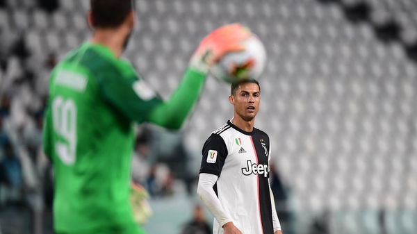 Cristiano Ronaldo looks on as AC Milan's goalkeeper Gianluigi Donnarumma prepares to clear the ball