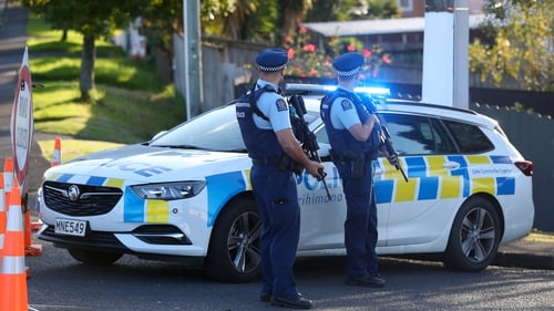Police are still searching for two suspects after the fatal shooting of an officer in Auckland