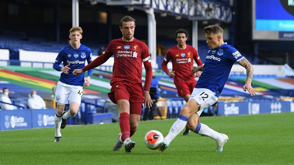 Everton's Lucas Digne and Liverpool's Jordan Henderson battle for the ball in the Merseyside derby at Goodison Park in June
