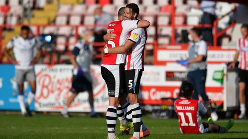 Tom Parkes of Exeter City (L) and Aaron Martin of Exeter City celebrate at the final whistle