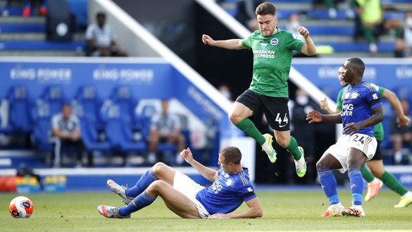Aaron Connolly hurdles Leicester's Jonny Evans