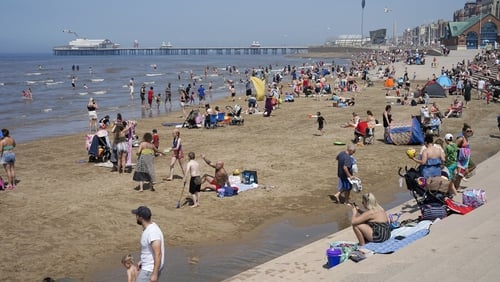 People on the beach in Blackpool, England today amid a summer heatwave with temperatures above 30C