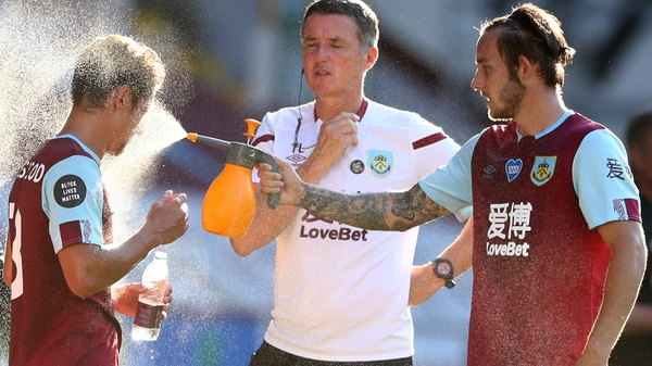 Burnley's Josh Brownhill (R) sprays water at team-mate Ashley Westwood during a drinks break
