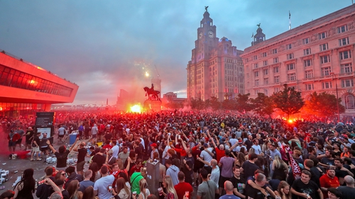 Liverpool fans let off flares outside the Liver Building in Liverpool