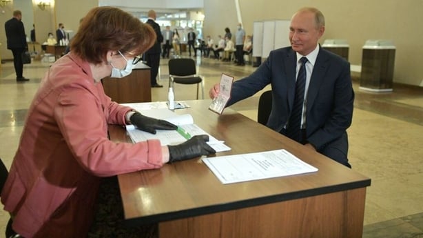 Vladimir Putin arriving to cast his vote yesterday at a polling station in Moscow