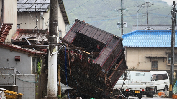 A collapsed house lies on a street in Hitoyoshi, Kumamoto prefecture
