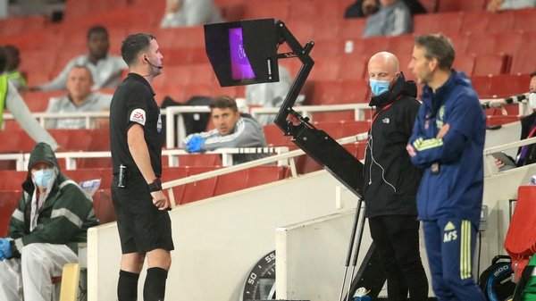 Referee Chris Kavanagh consults VAR prior to sending off Arsenal's Eddie Nketiah