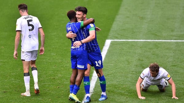 Kieffer Moore celebrates with Jamal Lowe Wigan's after scoring his team's fifth goal against Hull