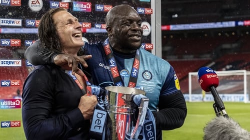 Adebayo Akinfenwa (R) has been invited to Liverpool's title parade