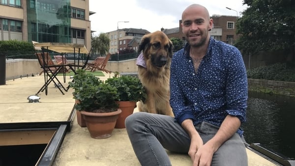 Gary and his dog, Kimba, on their houseboat on the Grand Canal