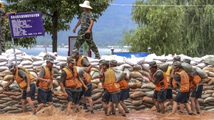Soldiers build a temporary embankment in Lushan city to hold back the rising water
