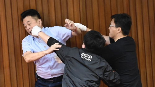 Taiwan's main opposition KMT politician Lu Ming-che (L) fights with ruling DPP's Wu Ping-jui (C) in parliament