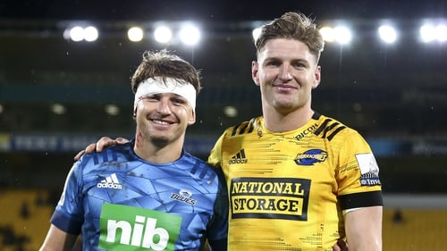 Beauden Barrett of the Blues and Jordie Barrett of the Hurricanes pose together after the match