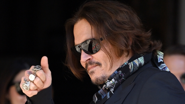 Johnny Depp acknowledges fans as he entered the court in London today