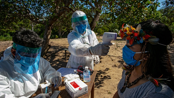 Medics conduct a coronavirus check on a member of an indigenous tribe in Brazil