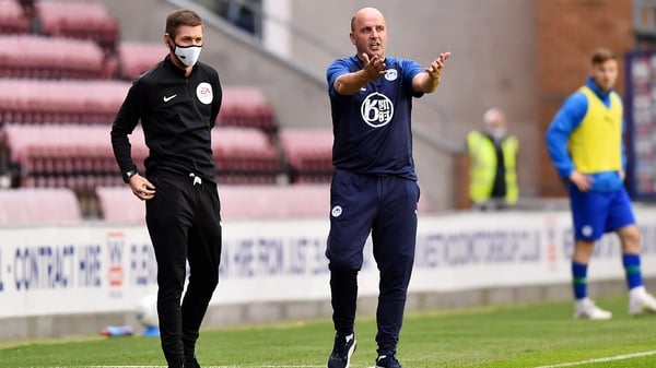 Paul Cook prowls the sideline during the draw against Fulham