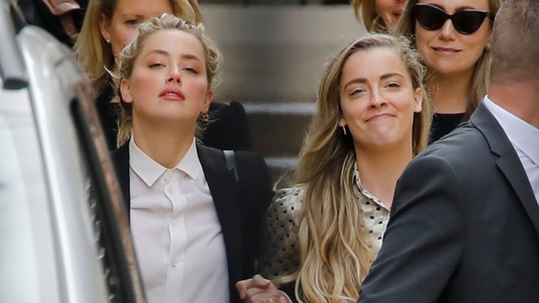Amber Heard leaves hand-in-hand with her sister Whitney Henriquez