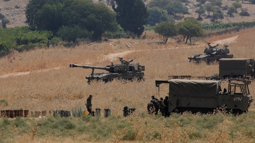 Armoured vehicles and self-propelled howitzers deployed in the Upper Galilee in northern Israel on the border with Lebanon today
