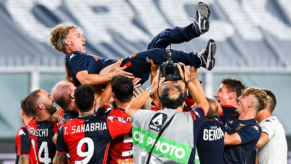 Davide Nicola, coach of Genoa, is lifted up by his players in celebration after safety was confirmed