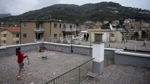 Carola Pessina (foreground) plays with Vittoria Oliveri on the rooftops of their homes during Italy's lockdown in April