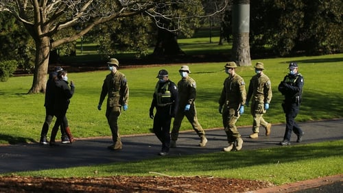 Police and army patrols are seen in the Fitzroy Gardens in Melbourne today