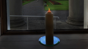A candle burns at Áras an Uachtaráin for John Hume