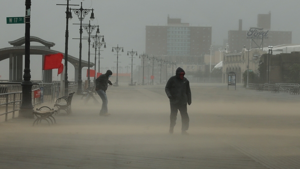 The Coney Island boardwalk stands mostly empty as Tropical Storm Isaias churns its way up the East Coast