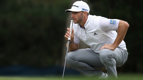 Dustin Johnson weighs up his putt on the 11th green during the third round