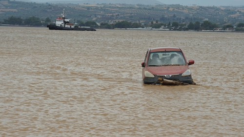 A car is swept away by flood waters off the Greek island of Evia
