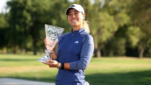 Danielle Kang celebrates with the trophy