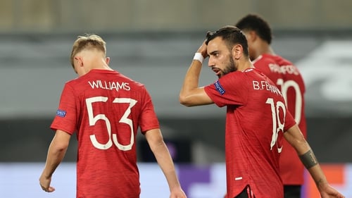 Bruno Fernandes (R) reacts after netting the winning penalty