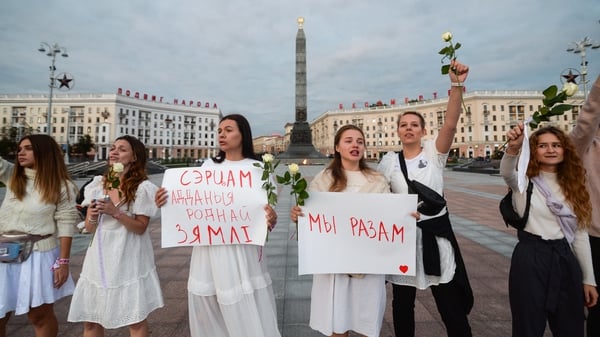 Women dressed in white as they formed a human chain today during protests in Minsk, Belarus