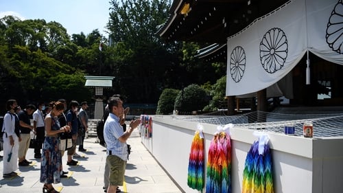 People pray at the Yasukuni shrine in Tokyo
