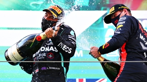 Race winner Lewis Hamilton and second placed Max Verstappen celebrate on the podium