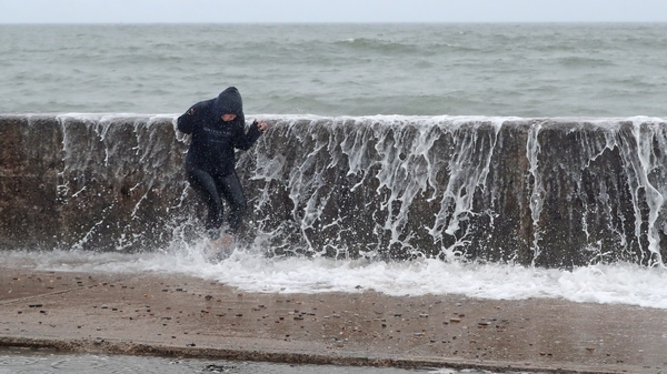 A person is hit by a wave crashing on the Front Strand today in Youghal, Co Cork