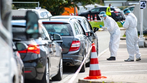 Medical personnel test motorists for Covid-19 at a rest stop on a motorway in Bavaria, Germany