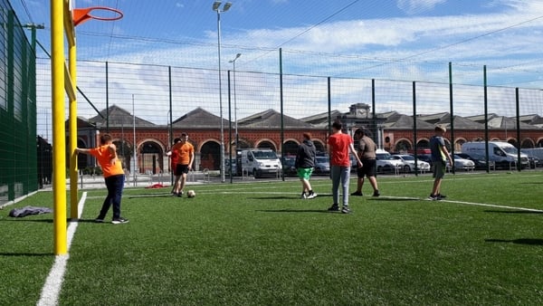 Children who are part of the Just Ask youth club play football near Greek Street flats