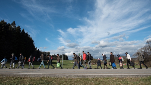 Refugees cross the border between Austria and Germany, on 18 November 2015 near Wegscheid, Germany